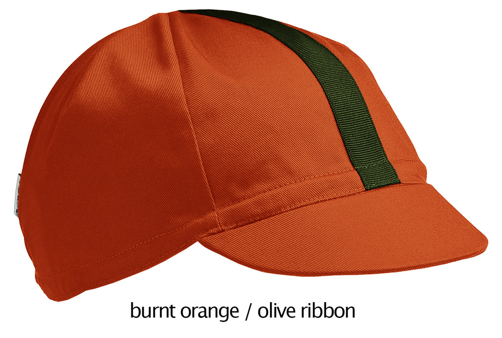 flat shot of the 4-panel cotton cap in burnt orange with a olive ribbon