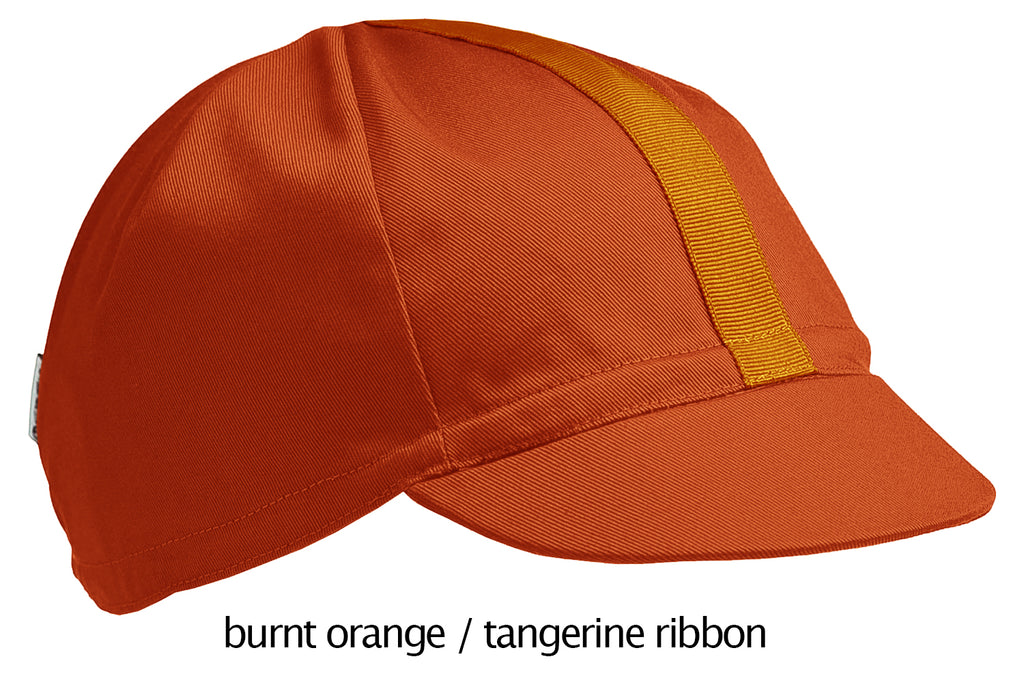 flat shot of the 4-panel cotton cap in burnt orange with a tangerine ribbon