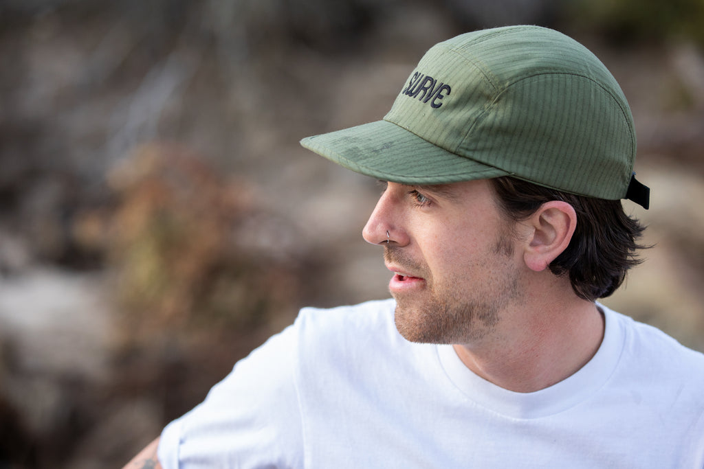 Colin in profile wearing the swrve 1968 logo embroidered CORDURA combat wool camp hat in green