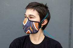 Roxy wearing the African cotton mask in cocoa pod in the adult fit