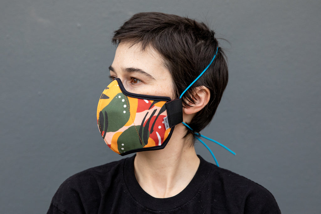 Roxy wearing the African cotton mask in mango chili in the adult fit