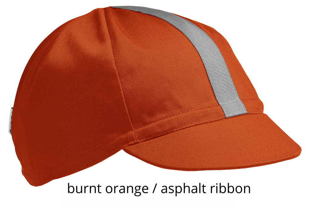 flat shot of the 4-panel cotton cap in burnt orange with an asphalt ribbon